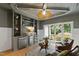 Cozy living room features custom shelving with beverage fridge and a view to the outdoor landscape at 1301 King Cross Ct, Raleigh, NC 27614