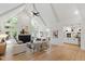 Open-concept living room boasts vaulted ceilings, fireplace, wood floors, and seamless flow into the modern kitchen at 1301 King Cross Ct, Raleigh, NC 27614
