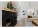 Bright living room features a black fireplace, light wood floors and a comfortable, neutral-toned sofa at 1301 King Cross Ct, Raleigh, NC 27614