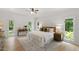 Airy main bedroom features natural lighting from wall to wall windows and hardwood floors at 1301 King Cross Ct, Raleigh, NC 27614