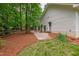 Charming side yard featuring lush greenery, brick accents, and a meticulously maintained garden at 1301 King Cross Ct, Raleigh, NC 27614