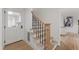 Staircase features wood treads, black iron railings and a lower entrance door at 1301 King Cross Ct, Raleigh, NC 27614