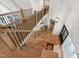 Bright staircase with wood steps, black railings, and large windows, providing a warm and inviting entrance to the home at 1301 King Cross Ct, Raleigh, NC 27614