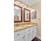 Bright bathroom featuring double sinks with granite countertops and framed mirrors at 14 Marigold Pl, Durham, NC 27705