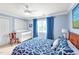 Serene bedroom with blue walls, patterned bedding, and a charming white crib at 14 Marigold Pl, Durham, NC 27705