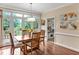 Charming dining area with wood table and chairs, adjacent to a sunlit deck through sliding glass doors at 14 Marigold Pl, Durham, NC 27705