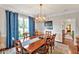 Elegant dining room with a large wooden table, blue curtains, and chandelier lighting fixture at 14 Marigold Pl, Durham, NC 27705