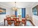Elegant dining room features stylish chandelier, blue curtains, and a beautiful wooden table with seating for six at 14 Marigold Pl, Durham, NC 27705