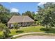 Aerial view of a brick house surrounded by trees and greenery, showcasing its well-maintained lawn at 14 Marigold Pl, Durham, NC 27705