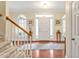 Spacious foyer with hardwood floors, staircase, decorative rug, and plenty of natural light at 14 Marigold Pl, Durham, NC 27705
