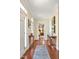 Inviting hallway with hardwood floors, artful decor, and a glimpse into a cozy bedroom at 14 Marigold Pl, Durham, NC 27705