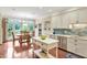 Spacious kitchen featuring a center island, stainless steel appliances, adjacent dining area with deck access at 14 Marigold Pl, Durham, NC 27705