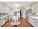 Lovely kitchen with stainless appliances, blue tile backsplash, central island, and hardwood floors at 14 Marigold Pl, Durham, NC 27705