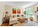 Comfortable living room featuring a sofa, ottoman, and decorative accents near a window at 14 Marigold Pl, Durham, NC 27705
