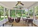 Bright sunroom with a ceiling fan, view to outdoor living area, and plenty of seating at 14 Marigold Pl, Durham, NC 27705