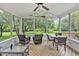 Bright sunroom with a ceiling fan, view to outdoor living area, and plenty of seating at 14 Marigold Pl, Durham, NC 27705