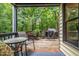 Inviting back porch with outdoor seating, a grill, and a view of lush greenery at 1426 Cedar Branch Ct, Wake Forest, NC 27587