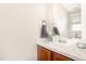 Clean bathroom featuring a vanity with a white countertop, a mirror, and a view of a window at 1426 Cedar Branch Ct, Wake Forest, NC 27587