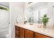 Bathroom with oak vanity, neutral countertop, large mirror, and decor elements at 1426 Cedar Branch Ct, Wake Forest, NC 27587