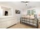 Bedroom featuring neutral walls, carpet, a ceiling fan, a large mirror, and a comfortable metal frame bed at 1426 Cedar Branch Ct, Wake Forest, NC 27587