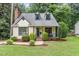 Charming exterior of a two-story home featuring dormer windows and manicured landscaping at 1426 Cedar Branch Ct, Wake Forest, NC 27587