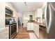 Updated kitchen with stainless steel appliances, granite countertops, and hardwood floors at 1426 Cedar Branch Ct, Wake Forest, NC 27587