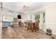 Open living and dining area featuring hardwood floors and large windows for natural light at 1426 Cedar Branch Ct, Wake Forest, NC 27587