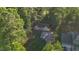 An aerial shot of a charming home nestled among lush green trees at 144 Shawnee Dr, Louisburg, NC 27549