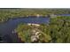 This aerial view showcases a lakeside community with lush trees and a beautiful lake at 144 Shawnee Dr, Louisburg, NC 27549
