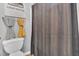 This cozy bathroom features a toilet and gray and yellow towels, as well as a Louis Vuitton piece of wall art at 144 Shawnee Dr, Louisburg, NC 27549