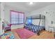 Cute bedroom with bunk beds, a large window, and bright colors at 144 Shawnee Dr, Louisburg, NC 27549