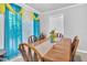 Bright dining room with large windows, seating for six, and modern decor at 144 Shawnee Dr, Louisburg, NC 27549