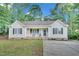 Charming single story home with a covered front porch, neutral siding, and manicured lawn at 144 Shawnee Dr, Louisburg, NC 27549