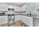 Bright kitchen with white cabinets, stainless steel appliances, and granite countertops at 144 Shawnee Dr, Louisburg, NC 27549