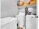 The laundry room features a washing machine, dryer, shelving, and other storage for home items at 144 Shawnee Dr, Louisburg, NC 27549