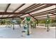 The outdoor gym has exercise equipment, overhead coverage and a view of the surrounding trees at 144 Shawnee Dr, Louisburg, NC 27549