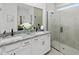Elegant bathroom with double vanities, granite countertop, a modern mirror, and a glass-enclosed shower at 148 Vaughan Farms Drive Dr, Angier, NC 27501