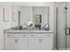 Bathroom features a double vanity, granite countertop, and a glass-enclosed shower for a modern look at 148 Vaughan Farms Drive Dr, Angier, NC 27501