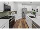Stylish kitchen featuring stainless steel appliances, white cabinets, and modern finishes at 148 Vaughan Farms Drive Dr, Angier, NC 27501