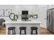 Well-appointed kitchen featuring white cabinets, stainless steel appliances, and a center island with seating at 148 Vaughan Farms Drive Dr, Angier, NC 27501