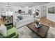 Open-concept living room flowing into a modern kitchen with white cabinets and hardwood floors at 148 Vaughan Farms Drive Dr, Angier, NC 27501