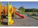 Fun playground with slide and swings for community enjoyment, set under a clear blue sky at 148 Vaughan Farms Drive Dr, Angier, NC 27501