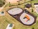 Aerial view of a community playground with swings, slides, and covered picnic area, ideal for outdoor Gathering time at 148 Vaughan Farms Drive Dr, Angier, NC 27501