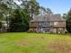 Green backyard of townhomes with well-manicured lawn surrounded by mature trees at 158 Pineland Cir, Raleigh, NC 27606