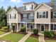 Inviting townhouse exterior featuring multiple units and manicured front lawns at 158 Pineland Cir, Raleigh, NC 27606