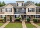 Charming townhome exterior with well-maintained landscaping and inviting front entrances at 158 Pineland Cir, Raleigh, NC 27606