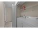 Functional laundry room with washer, dryer, and overhead shelving at 158 Pineland Cir, Raleigh, NC 27606