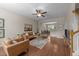 Open-concept living room with hardwood floors, ceiling fan, and dining area access at 158 Pineland Cir, Raleigh, NC 27606