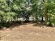 A partial, ground-level view of a grassy backyard area with surrounding trees at 166 Gulley Glen Dr, Garner, NC 27529