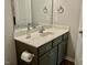 Bright bathroom with vanity, a countertop sink, framed mirror, and gray cabinets at 166 Gulley Glen Dr, Garner, NC 27529